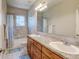 Bathroom featuring double sinks, a large mirror, and tiled shower-tub combination at 1362 Golden Eagle Way, Louisville, CO 80027