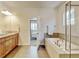 Bright bathroom features a soaking tub, glass shower, and dual sink vanity at 1362 Golden Eagle Way, Louisville, CO 80027