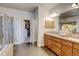 Bright bathroom features a soaking tub, glass shower, dual sink vanity, and walk-in closet at 1362 Golden Eagle Way, Louisville, CO 80027
