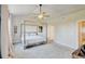 Open primary bedroom with vaulted ceilings, canopy bed, and neutral color palette at 1362 Golden Eagle Way, Louisville, CO 80027