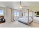Light-filled bedroom with vaulted ceilings, a four-poster bed and serene decor at 1362 Golden Eagle Way, Louisville, CO 80027