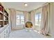 Bright and airy bedroom features a comfortable egg chair and plenty of sunlight at 1362 Golden Eagle Way, Louisville, CO 80027