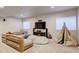 Comfortable bonus room featuring a sofa, large-screen TV, and play area at 1362 Golden Eagle Way, Louisville, CO 80027