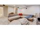 Comfortable bonus room featuring sectional seating, throw pillows, and a cozy atmosphere at 1362 Golden Eagle Way, Louisville, CO 80027