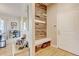 Inviting entryway with a custom wood accent wall, bench and storage baskets at 1362 Golden Eagle Way, Louisville, CO 80027