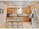 Well-lit kitchen with granite countertops, stainless steel appliances, and breakfast bar seating at 1362 Golden Eagle Way, Louisville, CO 80027