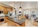 Spacious kitchen open to the living area with an island, stainless appliances and bar seating at 1362 Golden Eagle Way, Louisville, CO 80027