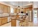 Well-lit kitchen with stainless appliances, a breakfast bar, and warm wood cabinets at 1362 Golden Eagle Way, Louisville, CO 80027