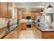 Well-lit kitchen with stainless appliances, granite counters and warm wood cabinets at 1362 Golden Eagle Way, Louisville, CO 80027