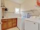 Well-equipped laundry room with modern appliances, counter space, and storage shelves at 1362 Golden Eagle Way, Louisville, CO 80027