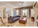 Comfortable living room with a fireplace, hardwood floors, and rustic wood accent wall at 1362 Golden Eagle Way, Louisville, CO 80027