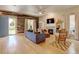 Bright living room with hardwood floors, fireplace, and unique reclaimed wood accent wall at 1362 Golden Eagle Way, Louisville, CO 80027