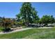 Community park with a playground, trees, benches, and walking path at 1362 Golden Eagle Way, Louisville, CO 80027