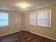 Bedroom with wood-look flooring and natural light from dual windows at 7331 Clay St, Westminster, CO 80030