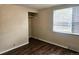 Bedroom featuring wood-look floors, window, and closet with shelving at 7331 Clay St, Westminster, CO 80030