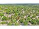 Aerial view of a home nestled among lush greenery in a well-treed neighborhood at 7030 S Fillmore Ct, Centennial, CO 80122