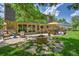 Spacious back patio area with seating, a fire pit, and lush lawn landscaping at 7030 S Fillmore Ct, Centennial, CO 80122