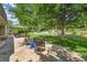 Seating area and lush backyard featuring well-maintained landscaping and mature trees at 7030 S Fillmore Ct, Centennial, CO 80122