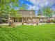 Sprawling backyard featuring a stone patio, dining set, and lush green lawn at 7030 S Fillmore Ct, Centennial, CO 80122