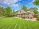 Large backyard with an outdoor kitchen, patio, grill, table and luscious lawn at 7030 S Fillmore Ct, Centennial, CO 80122