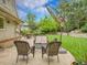 Cozy patio seating area with comfortable wicker furniture overlooking a meticulously landscaped backyard and lush lawn at 7030 S Fillmore Ct, Centennial, CO 80122