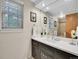 Bright bathroom featuring a large mirror, stylish vanity, and modern fixtures at 7030 S Fillmore Ct, Centennial, CO 80122