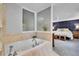 Bright bathroom features a soaking tub with tile surround and an opening that views into the bedroom at 7030 S Fillmore Ct, Centennial, CO 80122