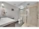 Bright bathroom with walk-in shower featuring gray tiling, updated fixtures, and recessed lighting at 7030 S Fillmore Ct, Centennial, CO 80122