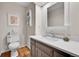 Half bathroom with brown vanity, white countertop, and wood-look floors at 7030 S Fillmore Ct, Centennial, CO 80122