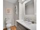 Charming powder room featuring a modern sink, white toilet, vanity, and light wood floors at 7030 S Fillmore Ct, Centennial, CO 80122