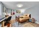 Cozy bedroom featuring a bed and side table, a desk for working, and eclectic decor at 7030 S Fillmore Ct, Centennial, CO 80122