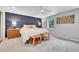 Primary bedroom with a paneled blue accent wall, neutral carpet, and ample natural light at 7030 S Fillmore Ct, Centennial, CO 80122