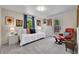 Bright bedroom featuring a white daybed with colorful pillows and a red reading chair with an ottoman at 7030 S Fillmore Ct, Centennial, CO 80122
