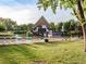 Inviting community pool area with lounge chairs, lush green grass, and a charming clubhouse at 7030 S Fillmore Ct, Centennial, CO 80122