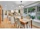 Open concept dining area with a view of the garden and a kitchen island perfect for entertaining guests at 7030 S Fillmore Ct, Centennial, CO 80122