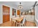 Dining room with wooden table and chairs set, bright lighting, and wood doors at 7030 S Fillmore Ct, Centennial, CO 80122
