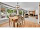 Open-concept dining area with natural light, views of the backyard, and hardwood floors at 7030 S Fillmore Ct, Centennial, CO 80122