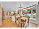 Dining room with bay window, with views of the lush backyard, and open to the kitchen at 7030 S Fillmore Ct, Centennial, CO 80122