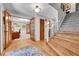 Inviting foyer with hardwood floors, staircase, and an adjacent office space at 7030 S Fillmore Ct, Centennial, CO 80122