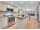 Open kitchen featuring stainless steel appliances, recessed lighting, an island, and an eat-in dining area at 7030 S Fillmore Ct, Centennial, CO 80122