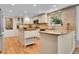 Bright kitchen featuring granite countertops, island, stainless steel appliances, and travertine backsplash at 7030 S Fillmore Ct, Centennial, CO 80122