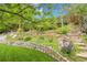 Stone retaining wall with lush planting beds accent the landscaped backyard at 7030 S Fillmore Ct, Centennial, CO 80122
