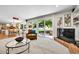 Bright living room with sliding doors, fireplace, and open to the kitchen and dining areas at 7030 S Fillmore Ct, Centennial, CO 80122