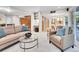 Bright living room with stylish furniture and an open floor plan that flows into the kitchen for easy entertaining at 7030 S Fillmore Ct, Centennial, CO 80122