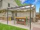 Outdoor patio area featuring a custom-built pergola bar with seating, ideal for entertaining and relaxing outside at 7030 S Fillmore Ct, Centennial, CO 80122
