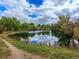 Scenic view of a tranquil pond surrounded by lush greenery and a walking path at 7030 S Fillmore Ct, Centennial, CO 80122