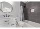 Modern bathroom with gray tiles, vanity, and a shower-tub combination at 8696 W 86Th Cir, Arvada, CO 80005