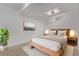 Modern bedroom features a platform bed, bedside tables, and unique wall art at 8696 W 86Th Cir, Arvada, CO 80005