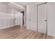 Bedroom with laminate flooring, drywall and baseboards, bi-fold closet and door leading to unfinished storage at 8696 W 86Th Cir, Arvada, CO 80005