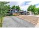 Cozy single-story home with driveway, brick accents, and gravel landscaping at 8696 W 86Th Cir, Arvada, CO 80005